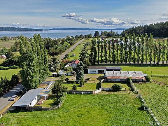 3 large pastures, guest house barn, garage and workshop carports, chicken house, and classic Farm House!