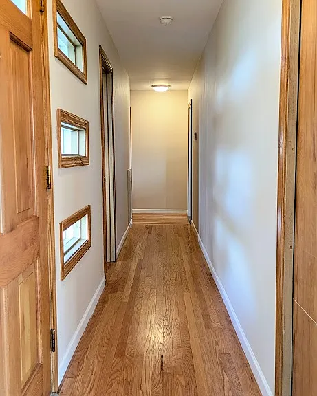 Hallway by the front door. Check out the mid century modern windows.