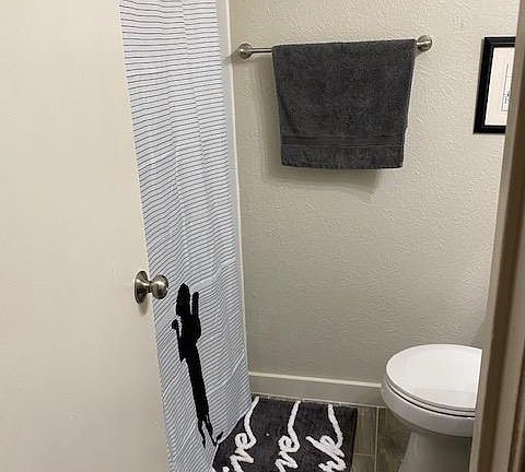 Both bathrooms have similar decor (dog-themed).