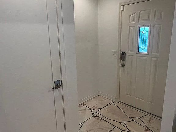 Front door and entryway closet. Cut out for a decorative table or welcome bench.