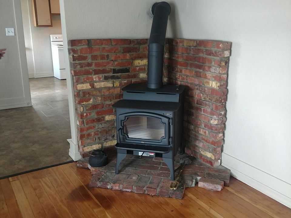 Original hardwood floors and brand new wood burning stove in
