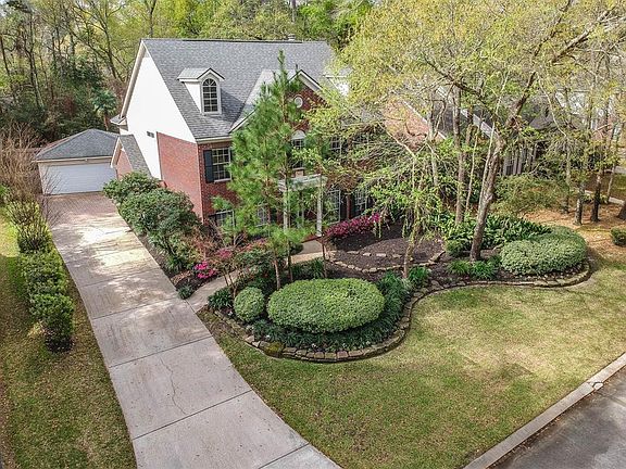 This aerial view highlights the lush landscape and ideal view of the home