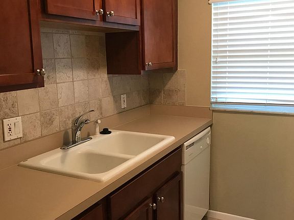 Kitchen with Maple cabinets & stone backsplash