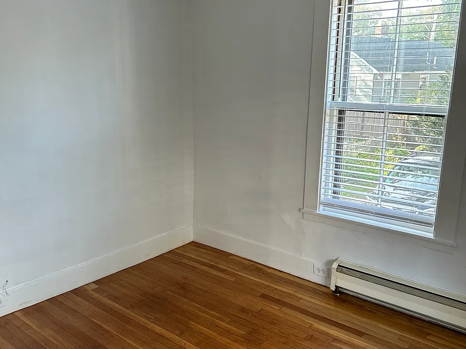 Rear bedroom with hardwood floors.