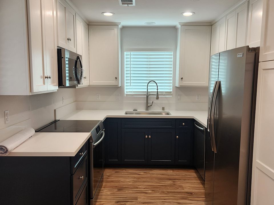 This stunning kitchen features two-toned custom cabinetry, premium Gallery appliances, and a sleek built-in dishwasher. With a modern design, ample storage, and elegant finishes, it blends functionality with style.