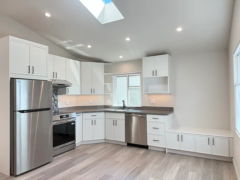 Custom built kitchen slim shaker style cabinetry, full kitchen appliances finished in stainless steel.