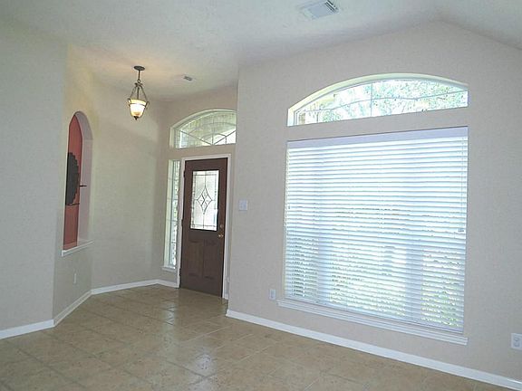 The entry features a leaded glass door, art niche and extensive tile flooring.