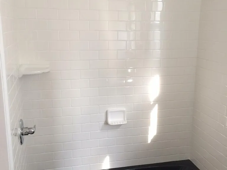 Newly tiled walls and floors w/tub