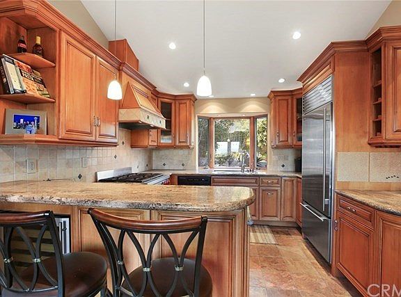 Upgraded custom cabinetry and Wolf 6-burner gas range.