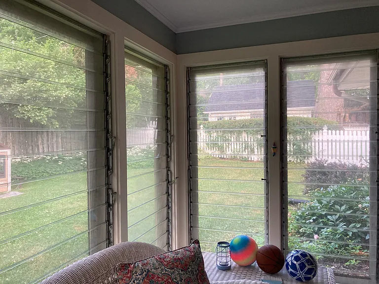 Sunroom with views of large fenced-in backyard