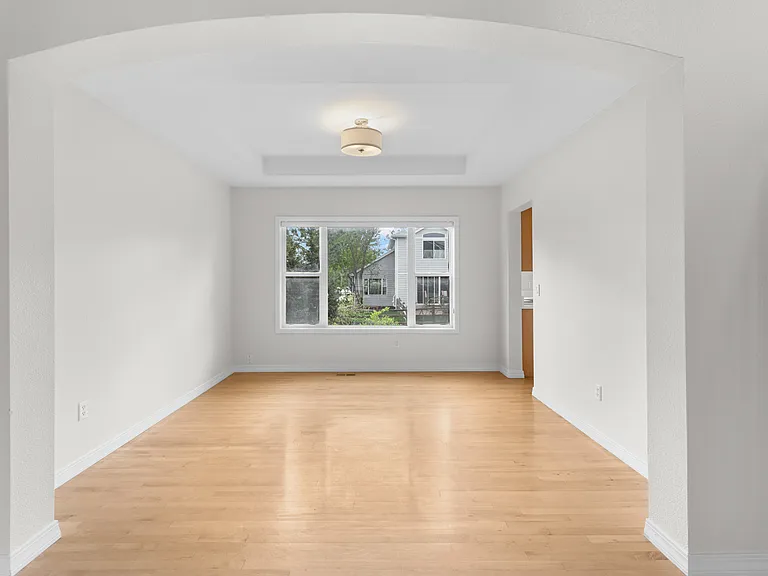 A spacious dining room is conveniently situated between the front living/sitting room and the kitchen, offering an ideal layout for both everyday living and entertaining.