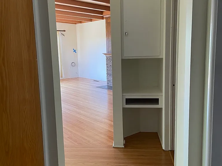 Entryway cove with branching access to living room, kitchen, bathroom and bedrooms