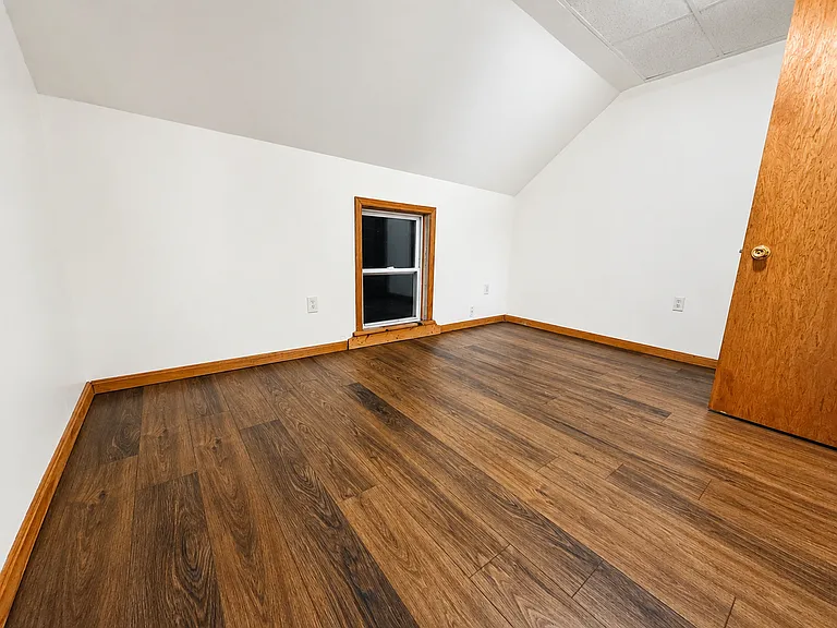 Second spacious bedroom with warm wood trim