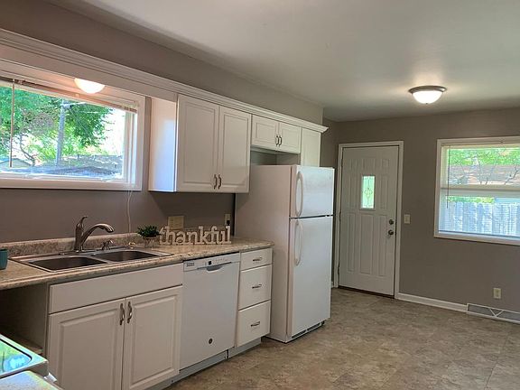 Designer gray walls, new faucet, appliances, newer cabinets, granite look countertop. Nice eating area in kitchen.