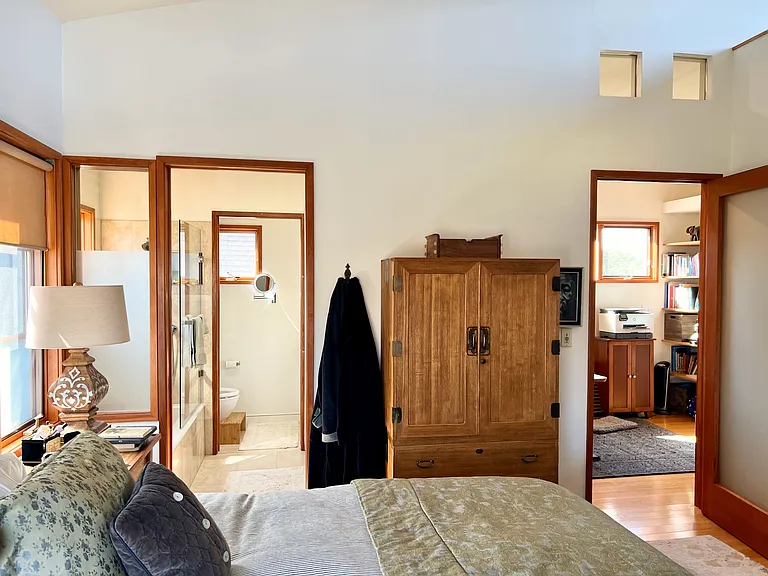 Primary Bedroom; en-suite bath beyond on the left; Den beyond on the right