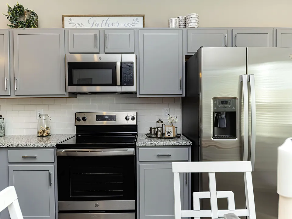 Kitchen with granite counters, stainless appliances, and modern cabinetry