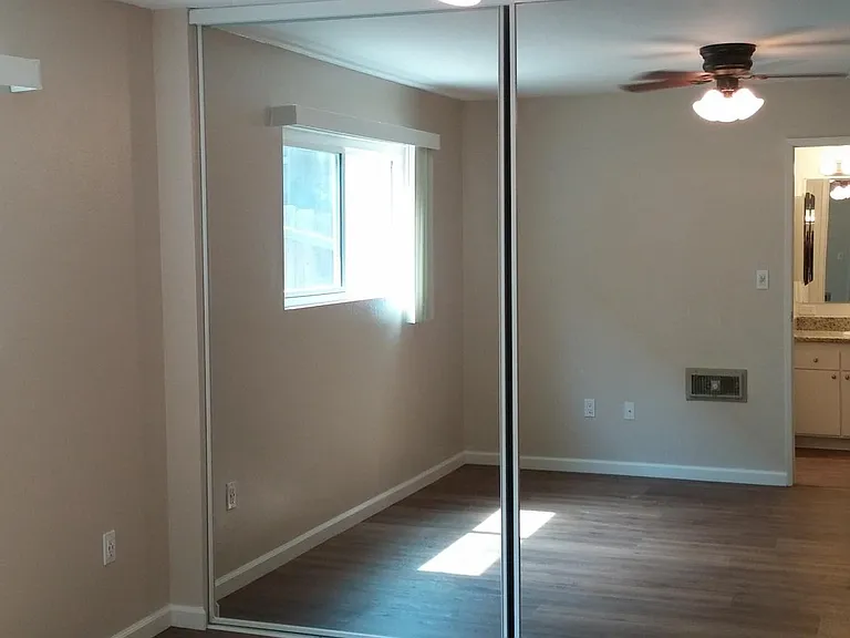 Mirrored wardrobe bedroom doors with ceiling fan