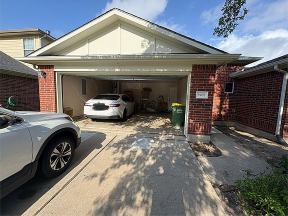 Front view with garage door open, the garage takes 2 cars