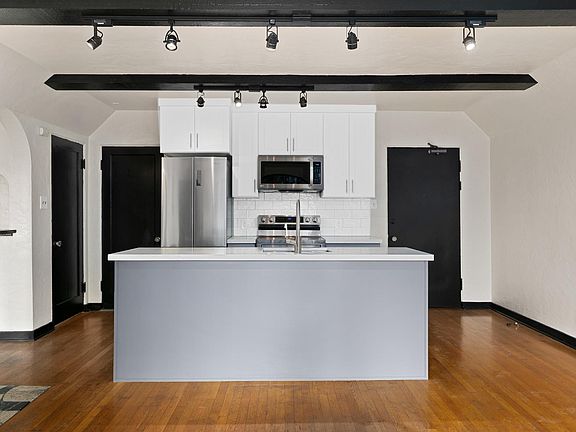 New kitchen island with deep stainless steel sink and built in dishwasher.
