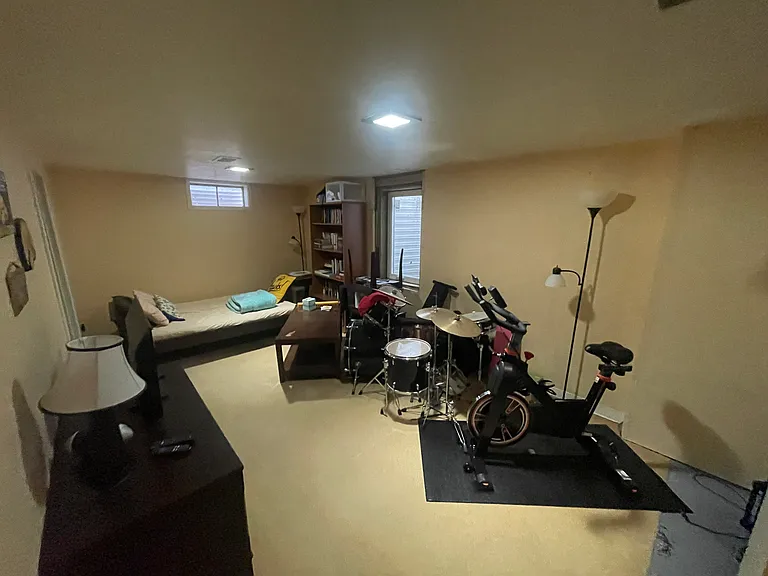 Basement living area from stairs, facing west.