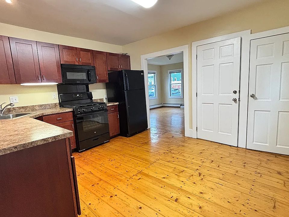 Kitchen, showing front door to unit, pantry door and doorway to living room