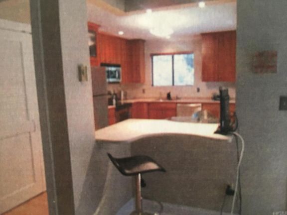 Open floor plan with high ceilings: built in desk/counter space between kitchen and living room.