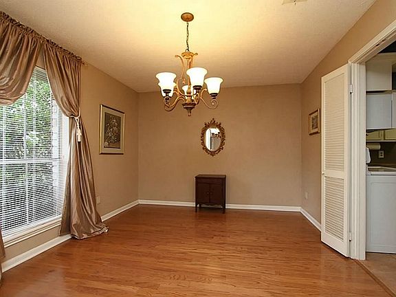 Notice the Dining room is down the hall with nice hardwood floors and pretty light fixture.and easy to get to the kitchen.