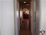 looking from master bedroom down hallway. arch is into kitchen. 