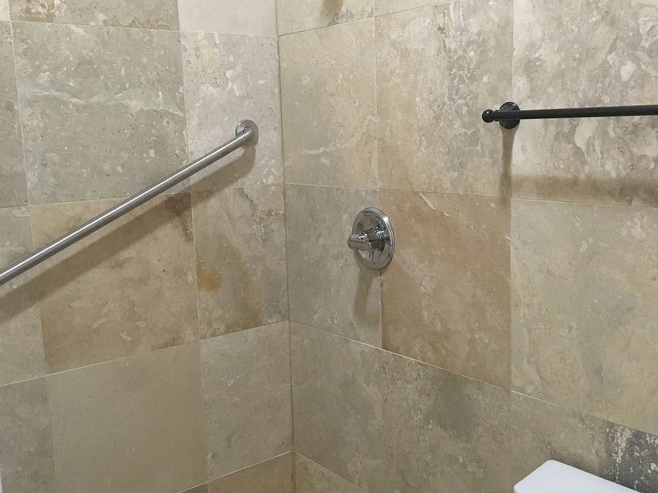 bathroom with hand rails