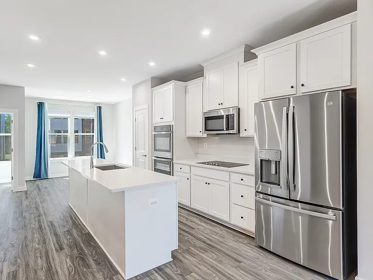 Modern open kitchen with quartz countertops, stainless steel appliances, and plenty of space for cooking and entertaining.