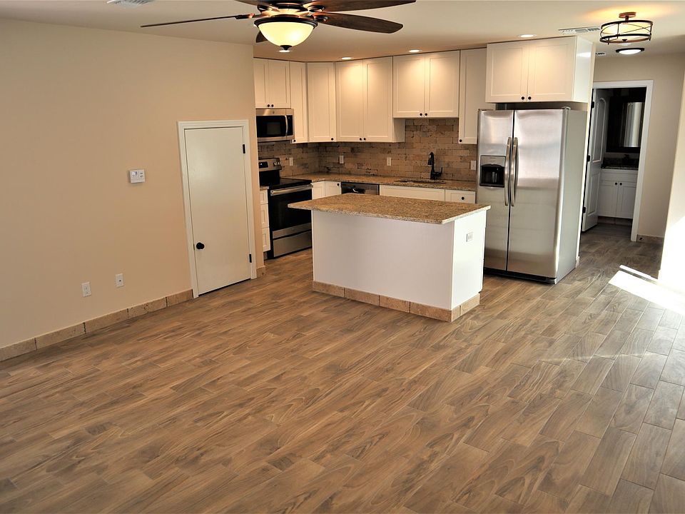 KITCHEN/STORAGE UNDER STAIRS DINING RM TO RIGHT WITH SLIDING GLASS DOOR GOING ON DECK, BEHIND KITCHEN IS 3RD BED ROOM,BATHROOM AT END OF HALLWAY LAUNDRY CLOSET TO RIGHT
