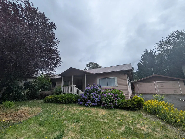 Front of home and 2-car garage and driveway.
