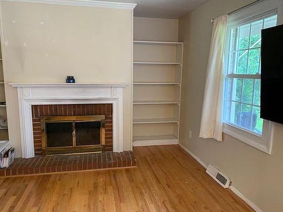 Family Room with fireplace bordered by built-in bookshelves.