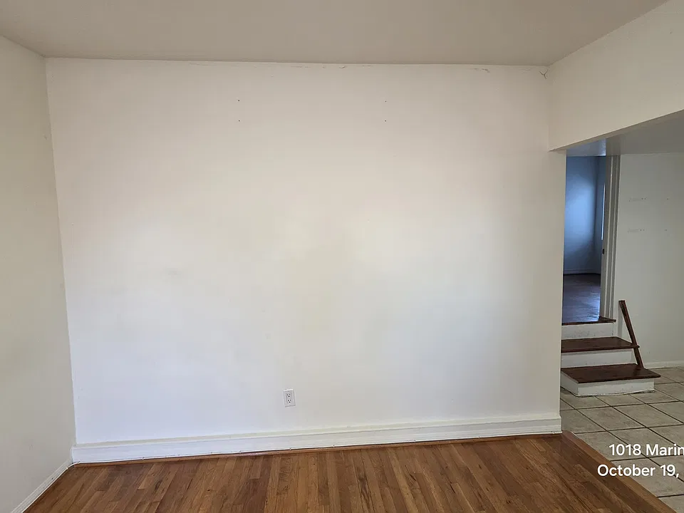 Living area with hardwood and kitchen with tile