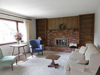 A grand living room with wood burning fireplace