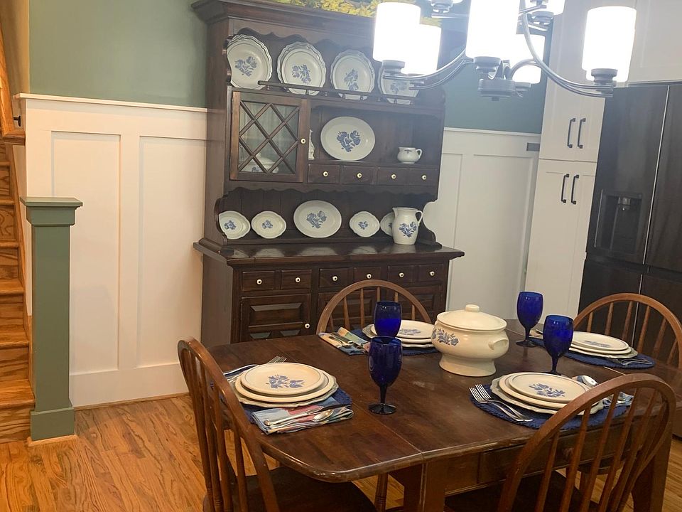 Eat-in kitchen with a table and four chairs, plus a hutch for storage.