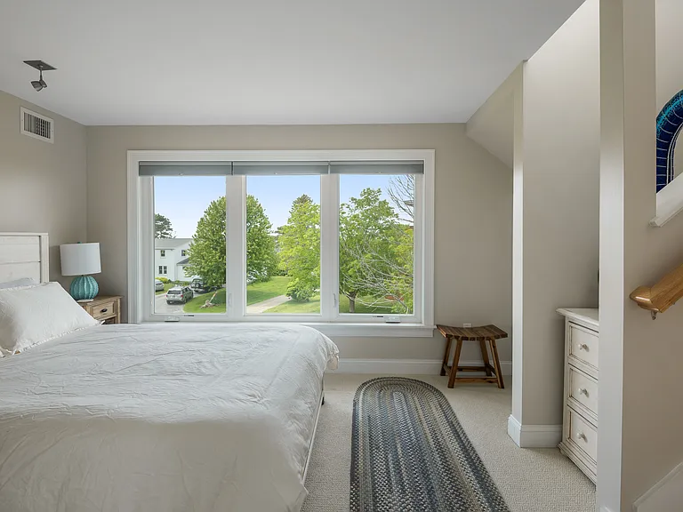 the third floor bedroom with a queen size bed