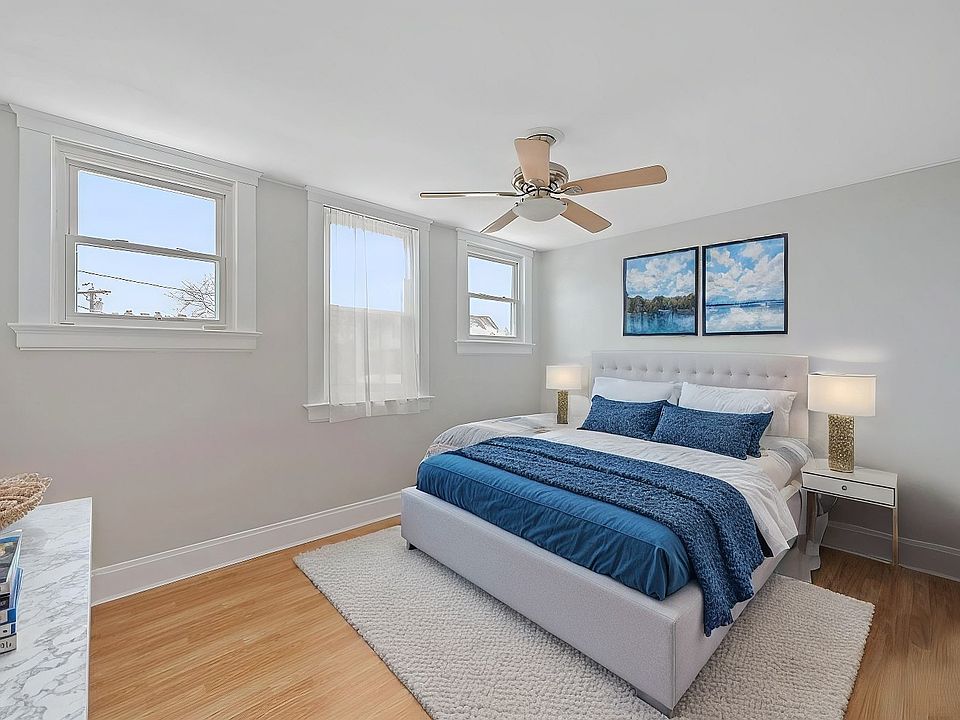 Large bedroom with hardwood floors and ceiling fan. Bedroom easily fits king size bed