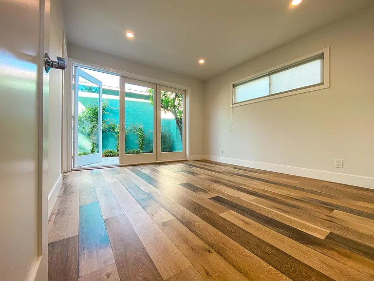 Wide-plank wood floors throughout house.