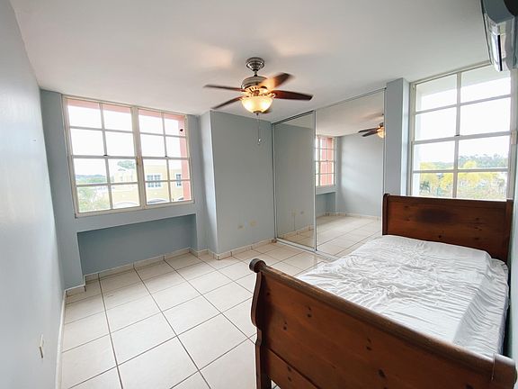 Bedroom 1 with ceiling fan and a/c.