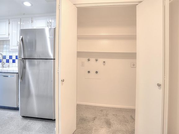 Laundry closet in small room off kitchen that could be used as a pantry.