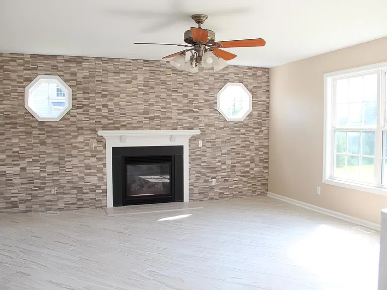 Living room, with beautiful tile wall and gas fireplace.