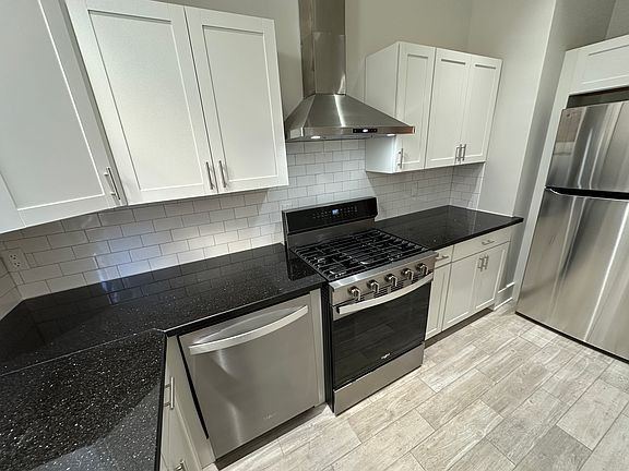 Fully renovated kitchen with granite countertops and all-new stainless steel appliances