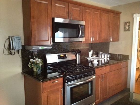 NEW CABINETS WITH GRANITE COUNTER TOP AND BACK SPLASH