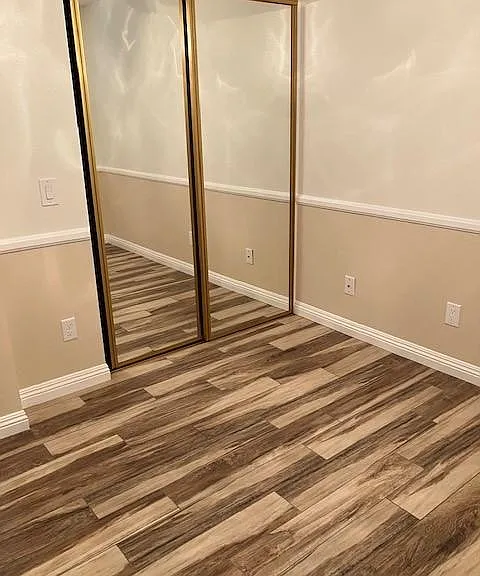 Bedroom with Gold Mirrored Closet Doors