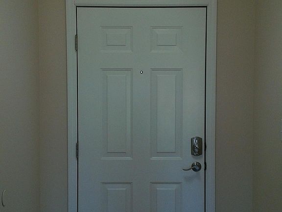 Entryway with art deco light. Front door has a Schlage keypad deadbolt lock. No key is needed to get in, just a four digit code. Multiple codes can be programmed so everyone has their own, including temporary guests.