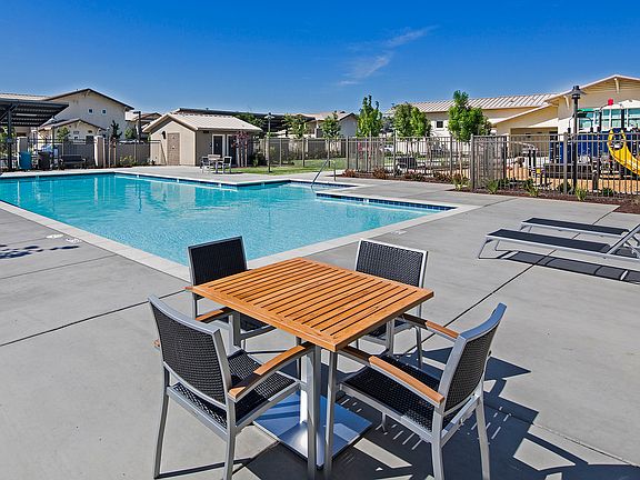 Relax and recharge by the poolside in this vibrant outdoor retreat.
