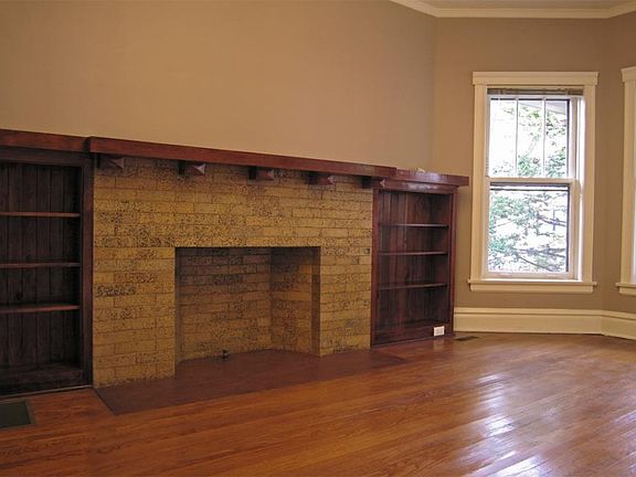 Living room with decorative fireplace, restored woodwork