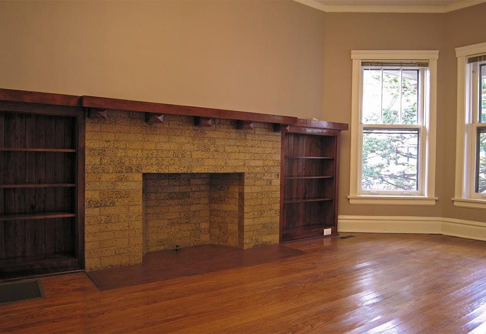 Living room with decorative fireplace, restored woodwork
