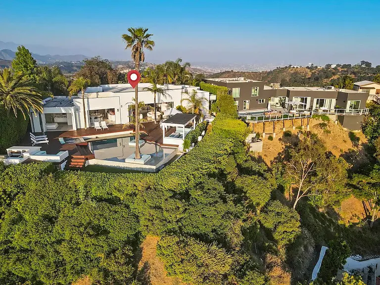 Enjoy a drone shot of the home surrounded by lush greenery, offering a picturesque escape in nature's embrace.